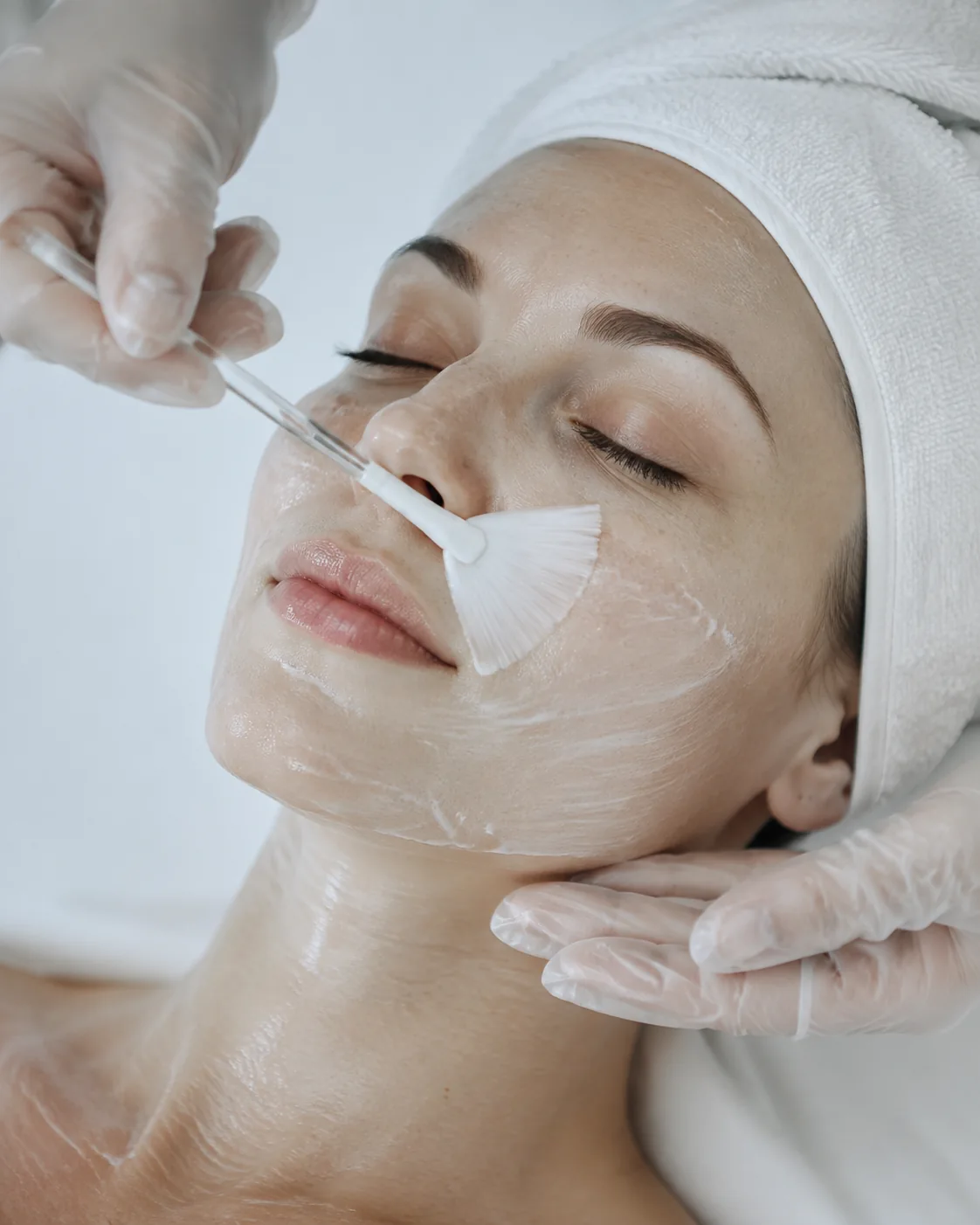 Editorial illustration of a facial cleansing ritual with a soft brush.